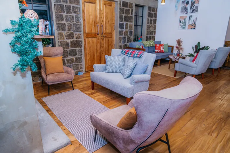 Hotel lounge with sofas, a stone wall and wooden doors